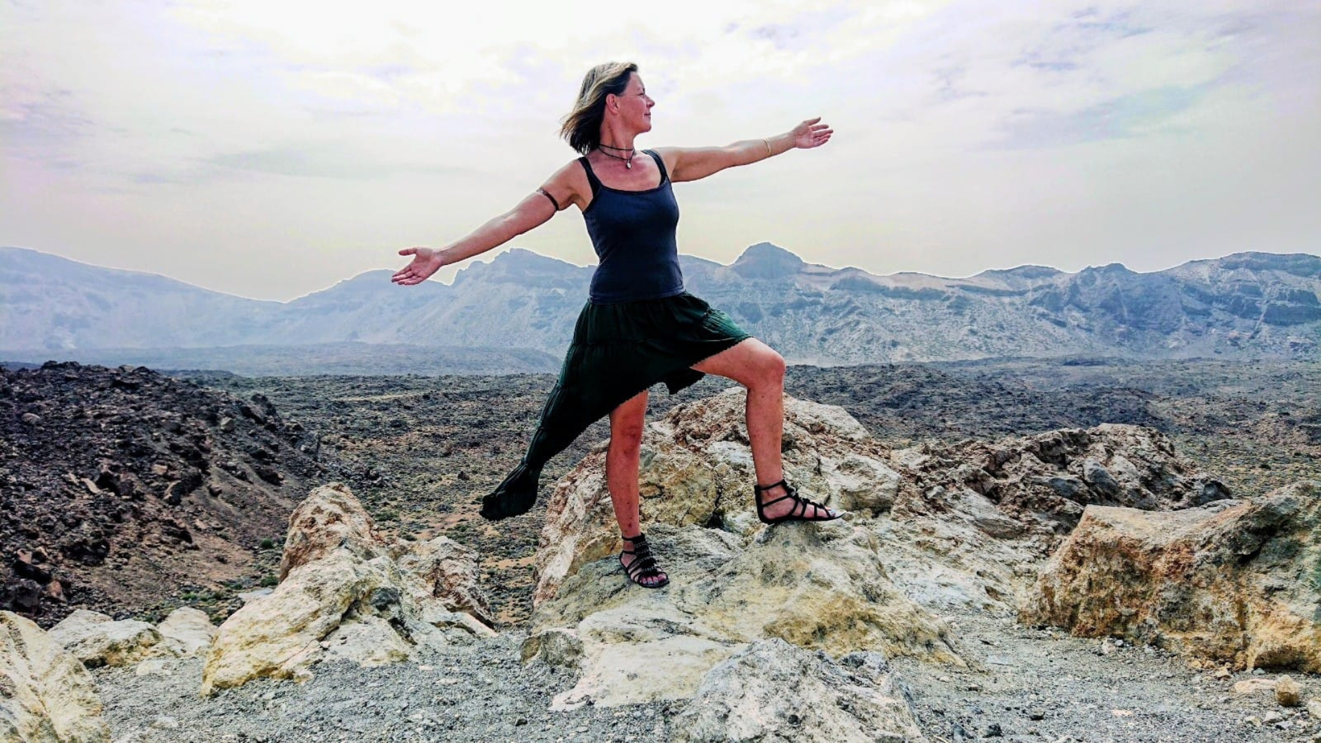 Corina Wiesemann mit ausgebreiteten Armen vor einem Bergpanorama